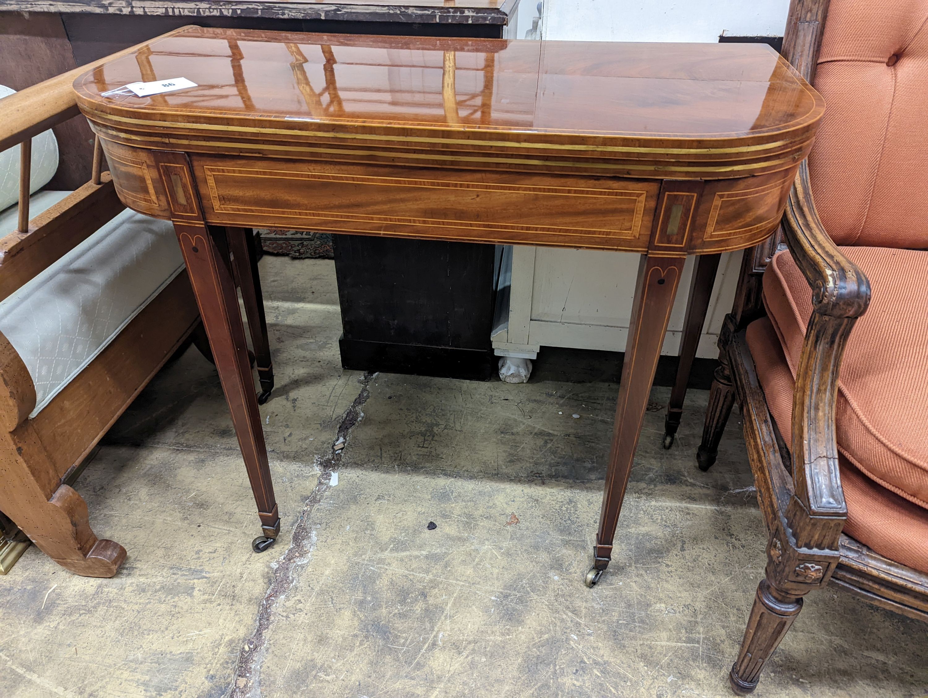 A Regency banded mahogany D shaped folding card table, width 90cm, depth 44cm, height 75cm